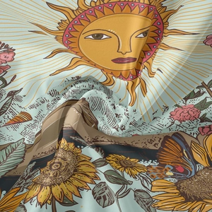 Close-up of soft fabric tapestry featuring sun, sunflower, and butterfly patterns