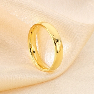 Macro shot of polished gold titanium wedding ring on elegant champagne silk background