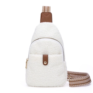 White sherpa fleece crossbody bag with brown leather trim and patterned woven strap