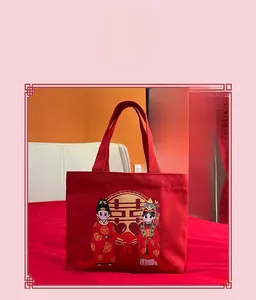 Detail of red bridal canvas bag with traditional gold Xi character and cartoon couple