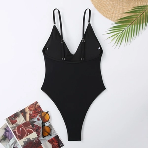 Detail of black one-piece swimsuit with adjustable straps and deep V-neckline