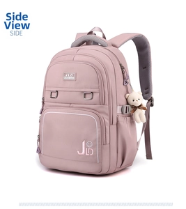 Close-up of lightweight pink student backpack with side pocket and plush bear pendant detail