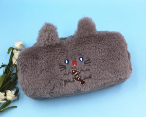 Detail of plush gray cat pencil case with 3D ears and embroidered kitten holding a fish