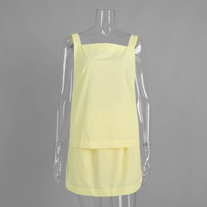 Detail of light yellow two-piece set featuring woven texture on top and matching skirt