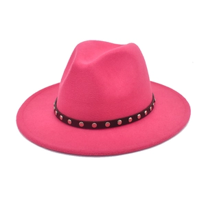 Close-up of rose red wool fedora hat featuring a leather band with silver metal studs