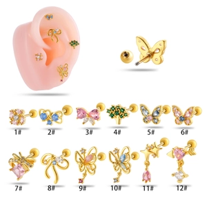 Detailed collection of 12 gold cartilage piercings with colorful butterfly and flower designs