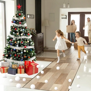 Kids playing with soft artificial snowballs near a decorated Christmas tree at home