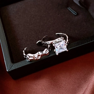 Macro view of silver adjustable rings with square zircon and lava texture detail