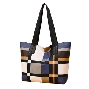 Classic plaid tote bag with blue and brown patchwork design and black shoulder straps
