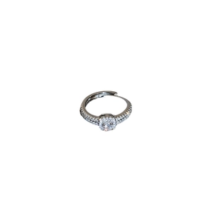 Sparkling silver geometric ring with cushion-cut zircon and pavé setting on white backdrop