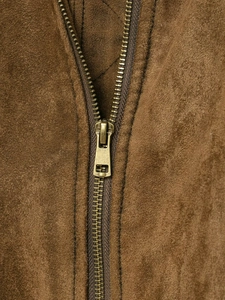 Detail of bronze metal zipper and precision stitching on brown suede jacket fabric