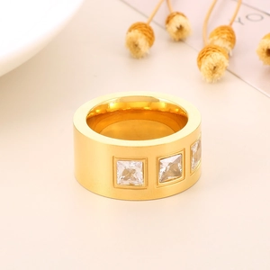 Detail of gold titanium steel ring featuring three square-cut sparkling zircon stones