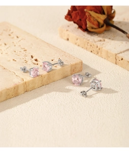 Close-up of S925 sterling silver studs with pink firework cut zircon on stone