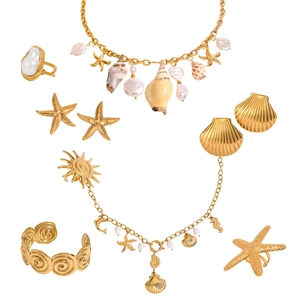 Golden ocean jewelry set with pearls and shells featuring starfish and sun motifs