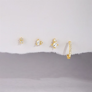 Detail of four-piece s925 silver earring set with gold plating and sparkling zircon stones