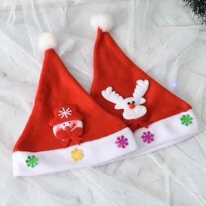 Kids and adults festive red Christmas hats with glowing snowman and reindeer plush appliques