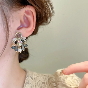 Vintage crystal teardrop earrings with pearls and rhinestones on model's ear