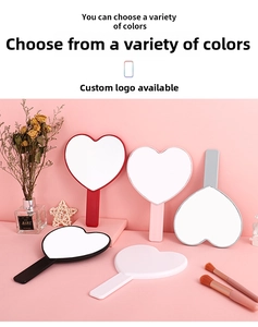 Macro shot of heart-shaped handheld mirror with ergonomic handle in various colors