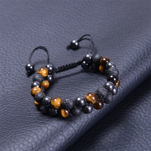 Detail of blue tiger eye and lava stone double-layer beaded bracelet on black leather