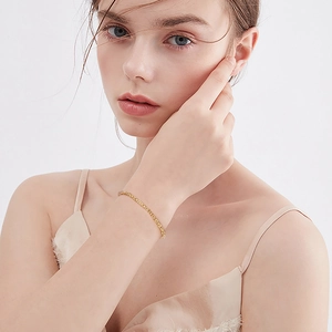Detailed close-up of 2.5mm Italian Byzantine gold bracelet worn on a woman wrist