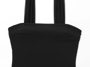 Detail of elegant black dress showing pleated mesh shoulder straps on white background
