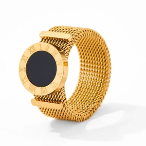 Detail of gold woven mesh ring with Roman numerals and black circular center inlay