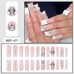 Pink French tip press-on nails with 3D bows, metal butterflies, and rhinestone accents