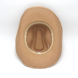 Detail view of woven straw hat interior with sweatband and spiral texture lining