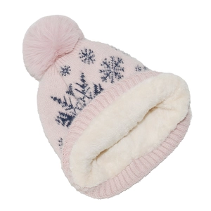 Detail of pink knitted winter hat with snowflake pattern and plush faux fur lining