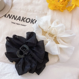 Large mesh bow hair claw clip for women, elegant black and white hair styling accessory.