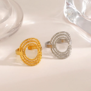 Minimalist stainless steel hollow round rings in gold and silver set on a clean background