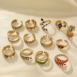 13-piece set of gold 18k plated enamel rings featuring evil eye, snake, and daisy designs