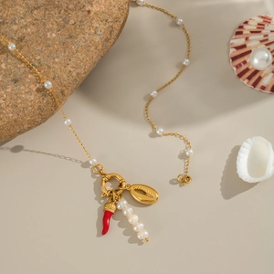 Gold pearl necklace featuring shell and red chili charms with elegant tassel detail