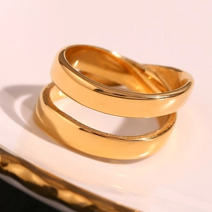 Close-up of polished 18K gold-plated double-layer crisscross ring with shiny finish