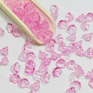 Macro detail of translucent pink lily-of-the-valley glass beads for DIY jewelry making
