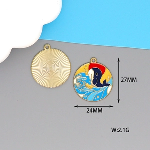 Detailed view of alloy wave whale pendant showing 24mm diameter and golden texture