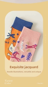 Detail view of cotton socks with orange cat motif and pink pony jacquard patterns