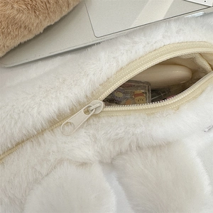 Detail of soft white plush pencil case showing smooth zipper texture and interior lining