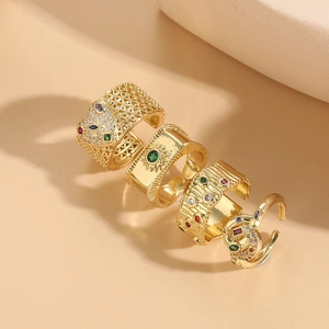 Detailed view of four 14K gold plated geometric rings with zircon and colorful gemstones