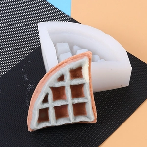 Detail of a semi-circular silicone waffle mold showing the texture and finished sample