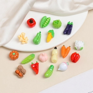 Close-up of assorted miniature resin vegetables including tomatoes and carrots for DIY crafts