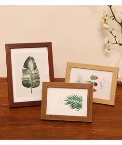 Three wooden photo frames in walnut and oak finishes showing 5x7, 4x6, and 3.5x5 inch sizes