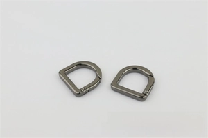 Detail view of two gunmetal D-ring spring buckles for leather bags and straps
