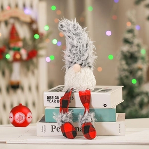 Close-up of handmade Christmas gnome with grey plush hat and red black plaid legs