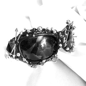 Punk aesthetic black sunglasses with silver metal studs and spikes on fluid frame
