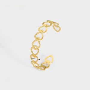 Detail showing the 1.26cm width and 8.6g weight of the gold heart cutout bangle