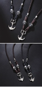 Detail of vintage anchor pendants and skull beads on woven leather cords