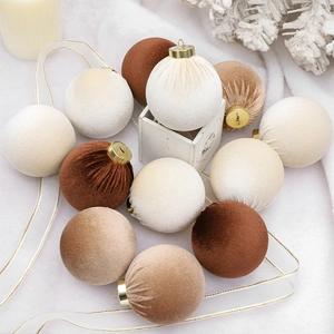 Set of 8cm velvet Christmas balls in white, beige, and brown on a soft white blanket