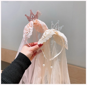 Detail of pink and ivory girls' crown headbands with lace mesh veils and pearl tassels