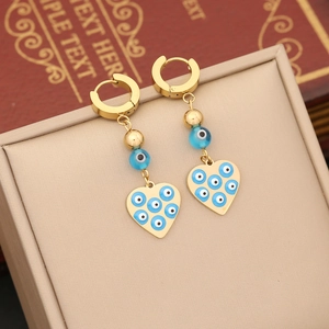 Golden hoop earrings with blue bead and heart charms featuring evil eye patterns